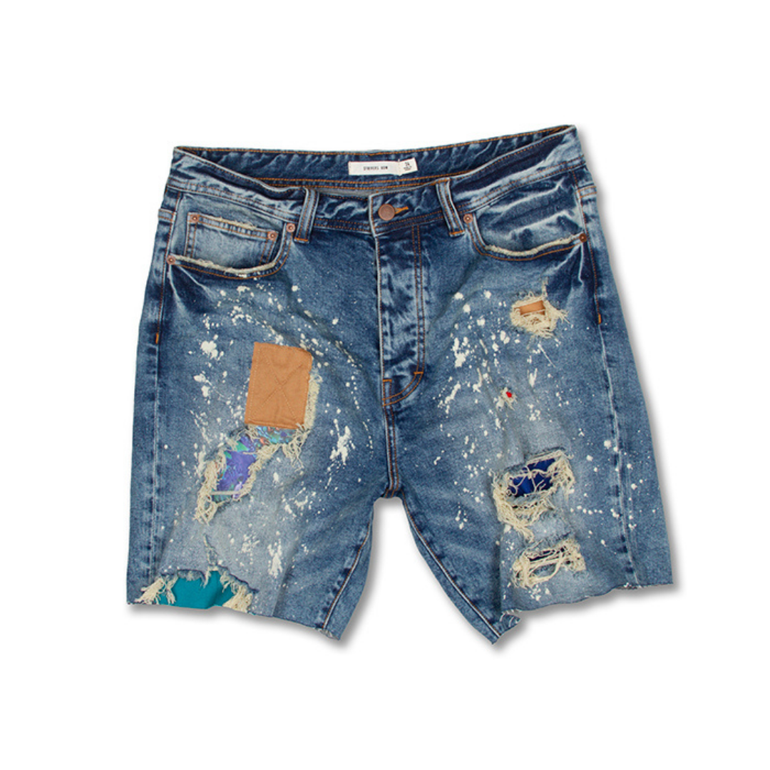 A pair of Alpine Jean Shorts with holes in them.